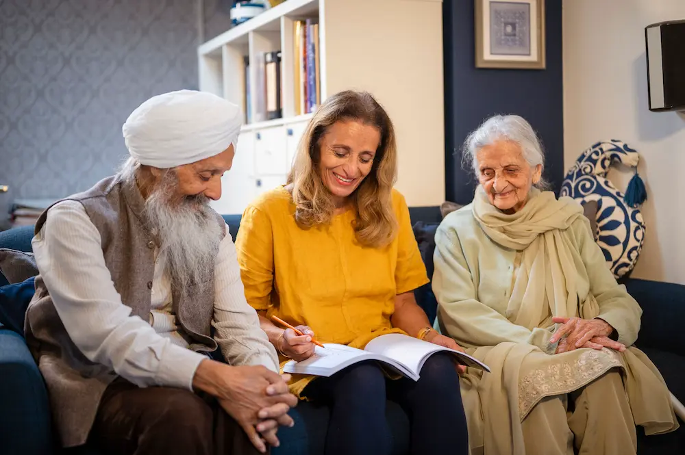 Female carer with two older adults