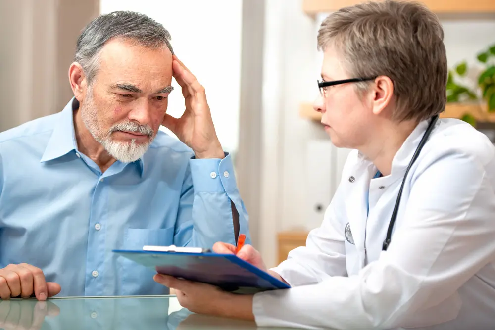 Female doctor speaking to male patient