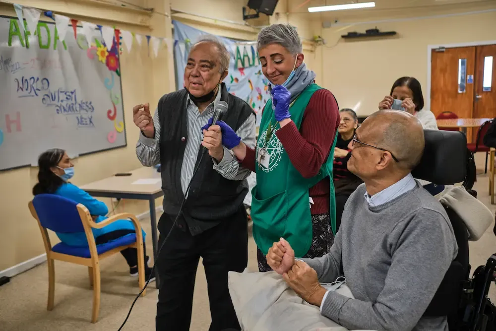 Group of older adults and a female carer
