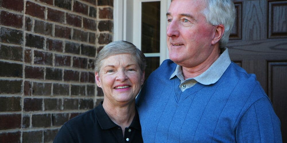 A couple stood outside their jointly owned home