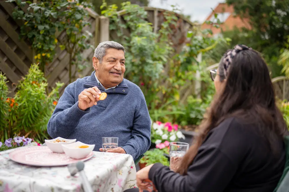 Man and younger woman eating biscuits together