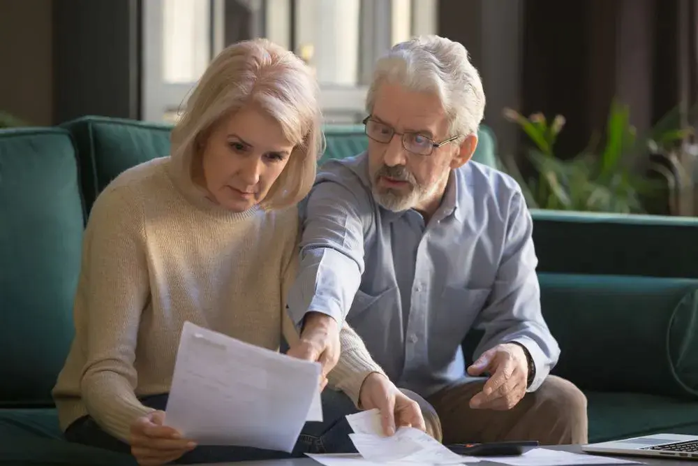 Old couple reading documents together