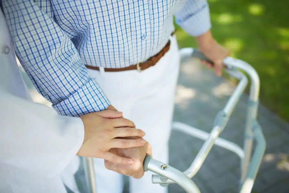 Older adult getting help with walking