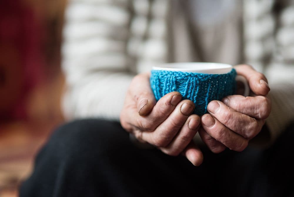 Older adult holding a cup of tea