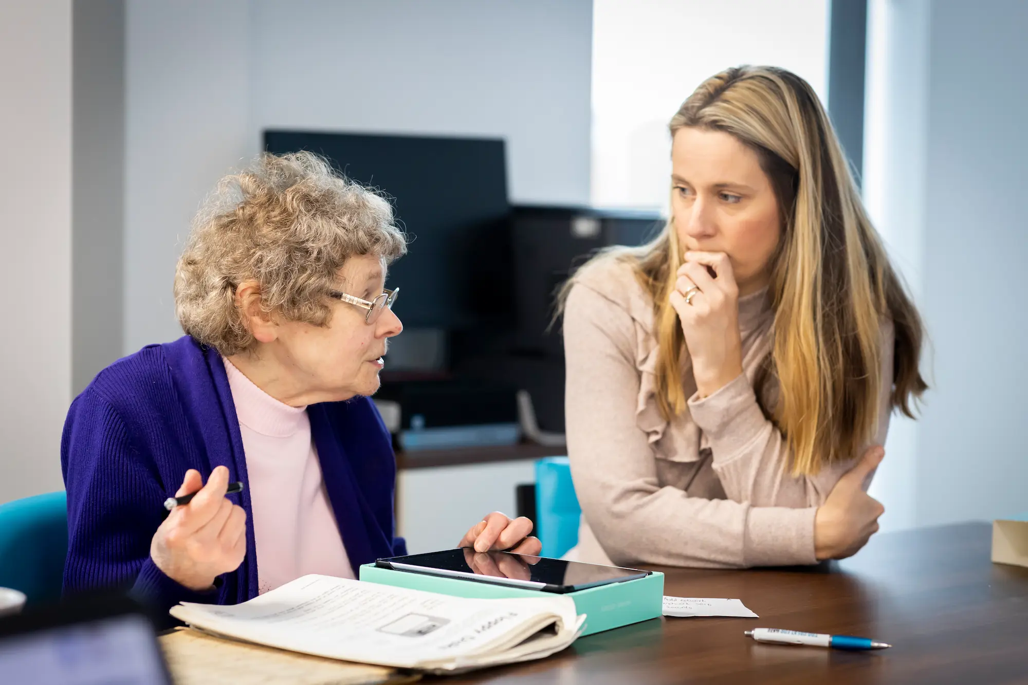 Older and younger woman using a tablet together