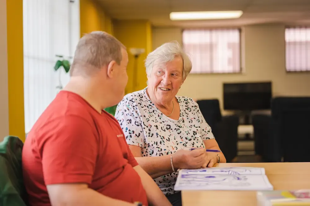 Older female carer and man