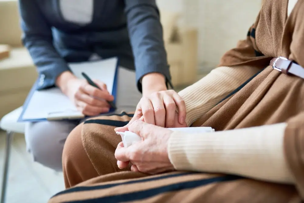 Older person being comforted by a carer