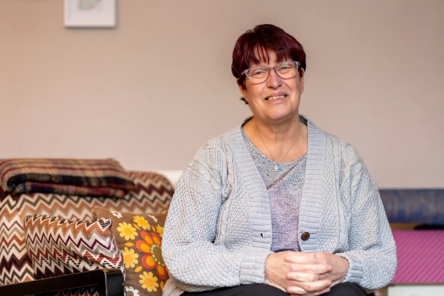 Older woman smiling while sat down