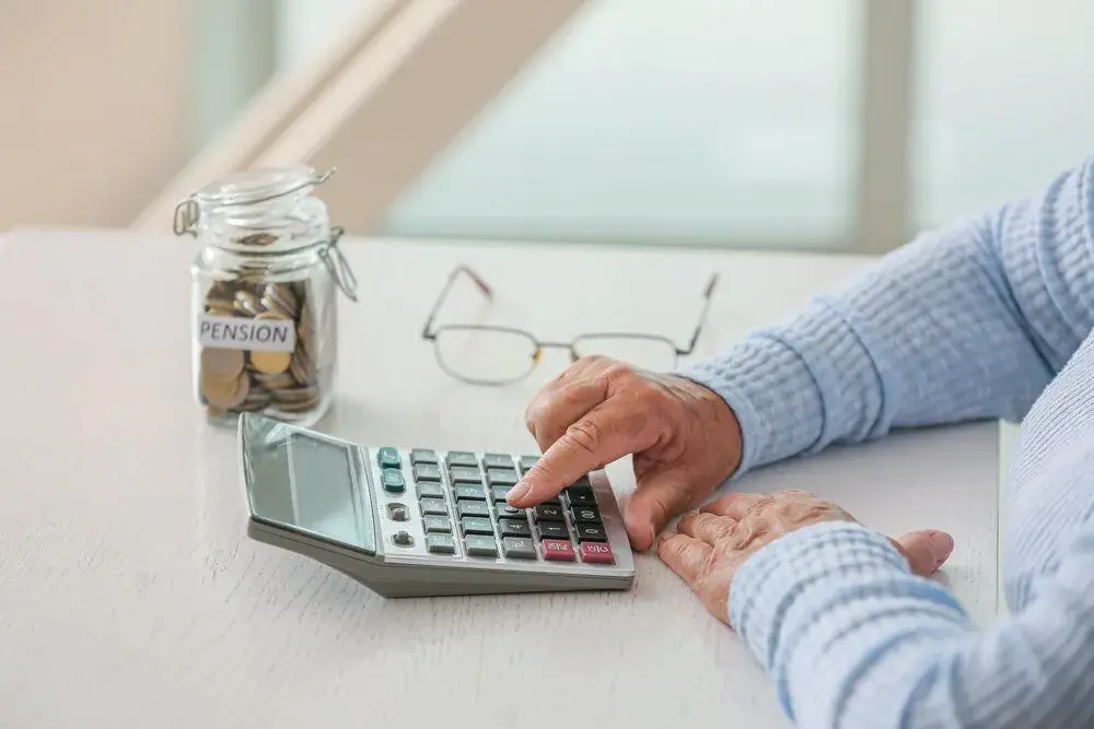 Older woman with a pension pot and calculator