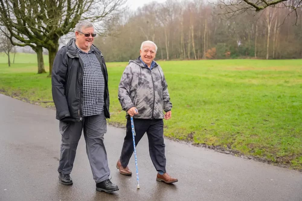 Two older men walking in a park