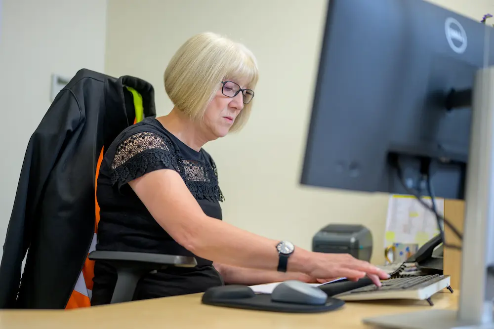 Woman over 50 working behind a desk