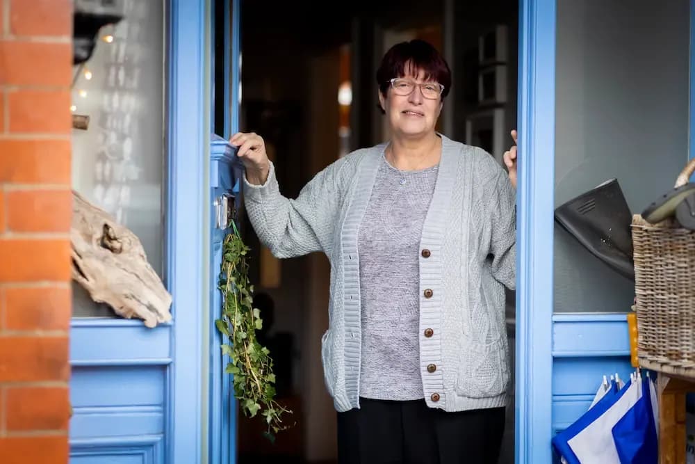 Woman stood in her doorway