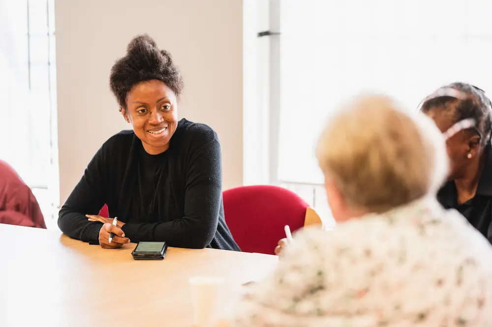 Younger woman speaking to older woman