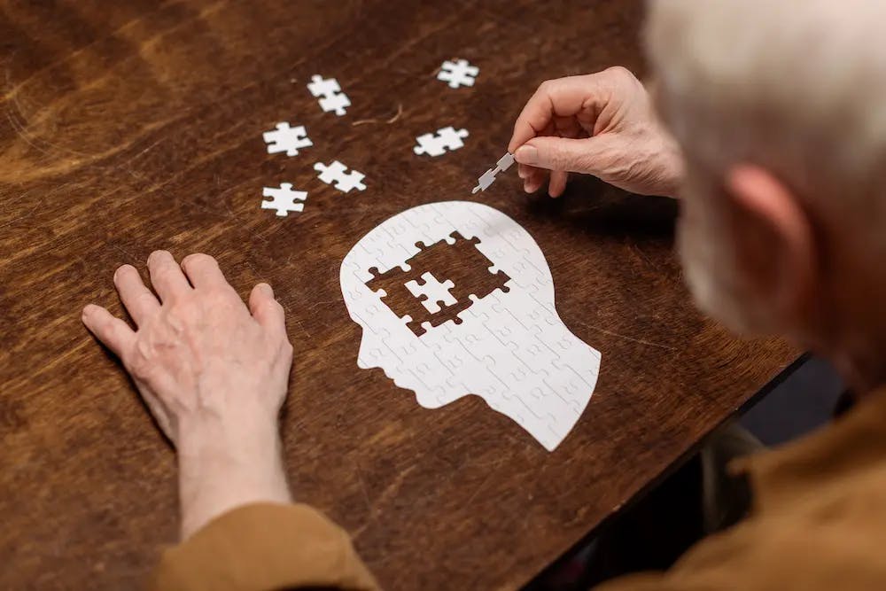 Man doing a jigsaw of the brain and head