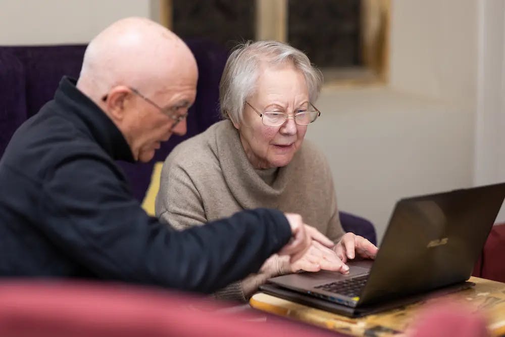 Older man and women using a laptop