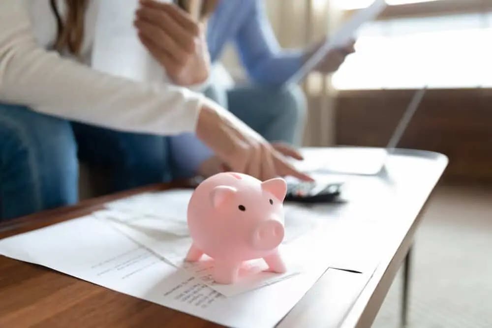 Piggy bank on top of financial documents