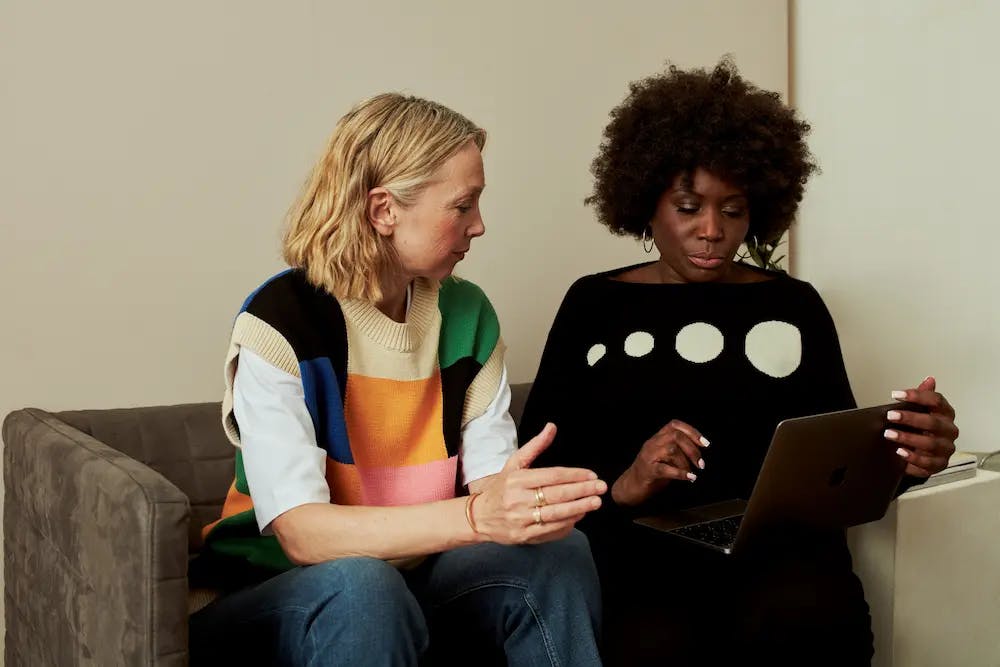 Two women using a laptop together