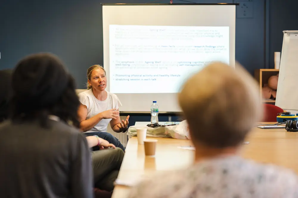 Younger woman giving a presentation on promoting independence in care