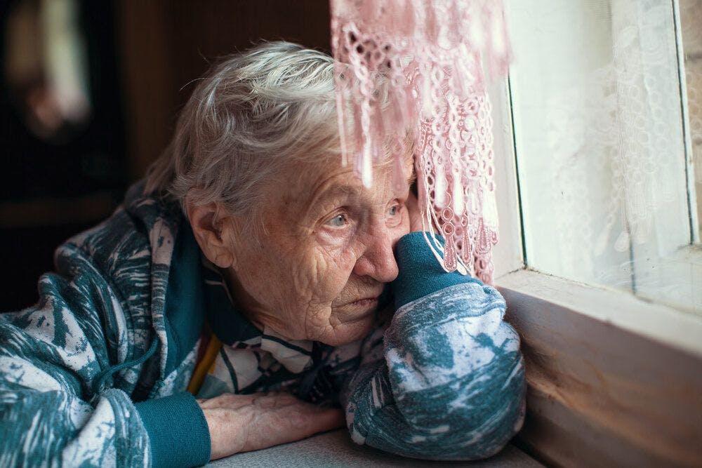 An elderly woman looking lonely