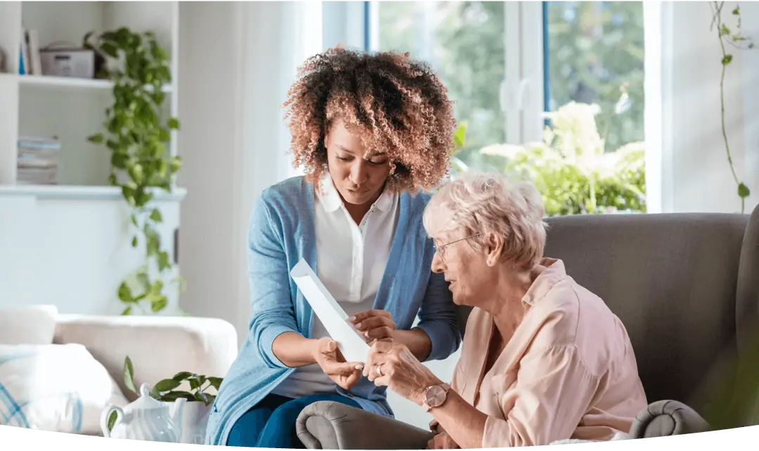 A woman talking to a care home resident